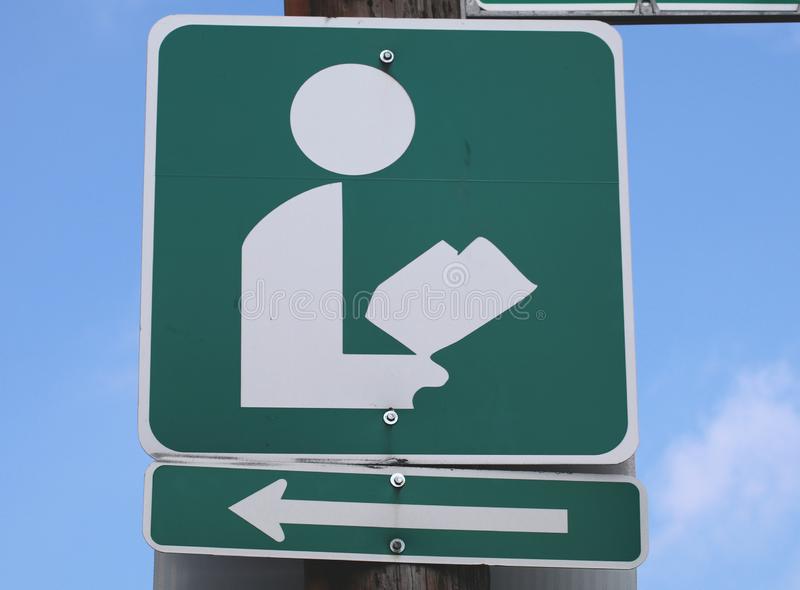 sign-using-symbol-arrow-directions-to-public-library-156352444.jpg